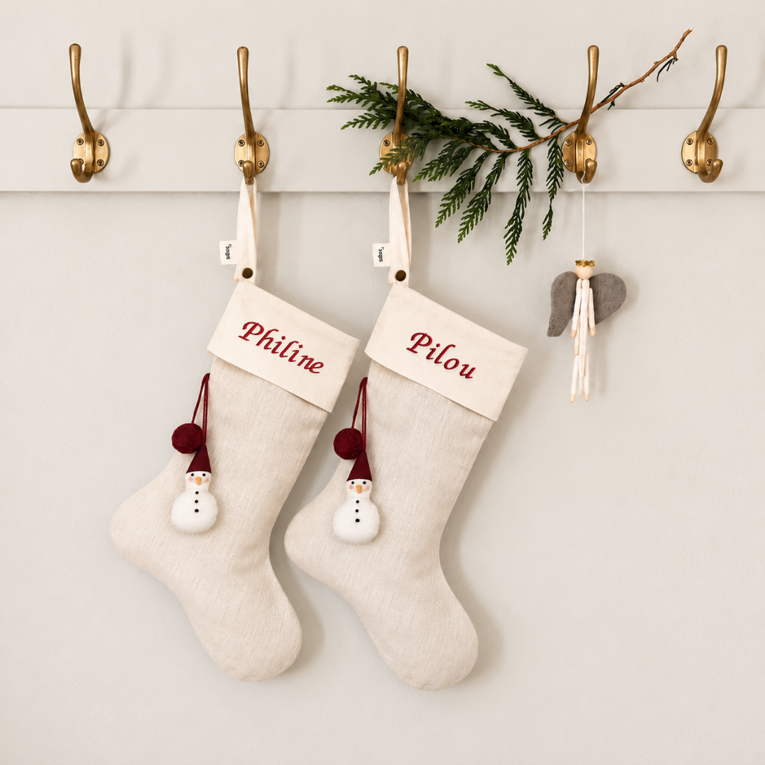 Two personalised snowman stockings embroidered Philine and Pilou on brass hooks